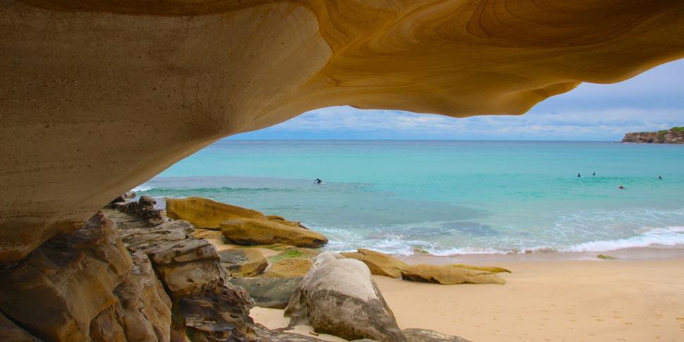 Free Image of View of a Beach From a Cave 