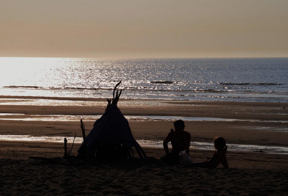 Free Image of Person and Child Playing Near Teepee on Beach 