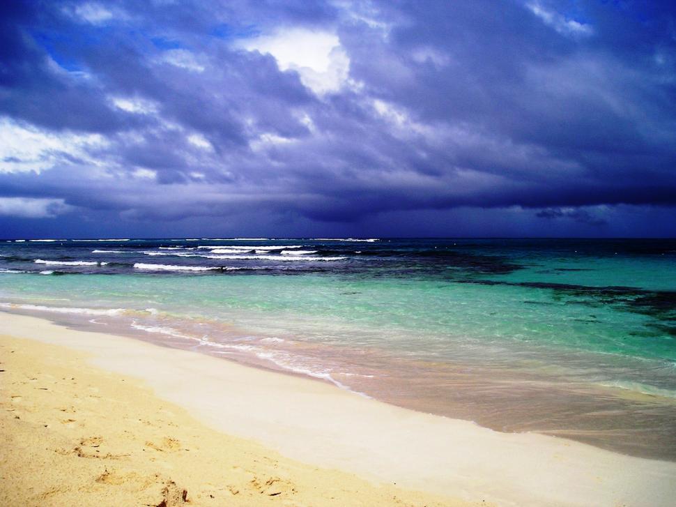 Free Image of Beach With Water and Clouds. 