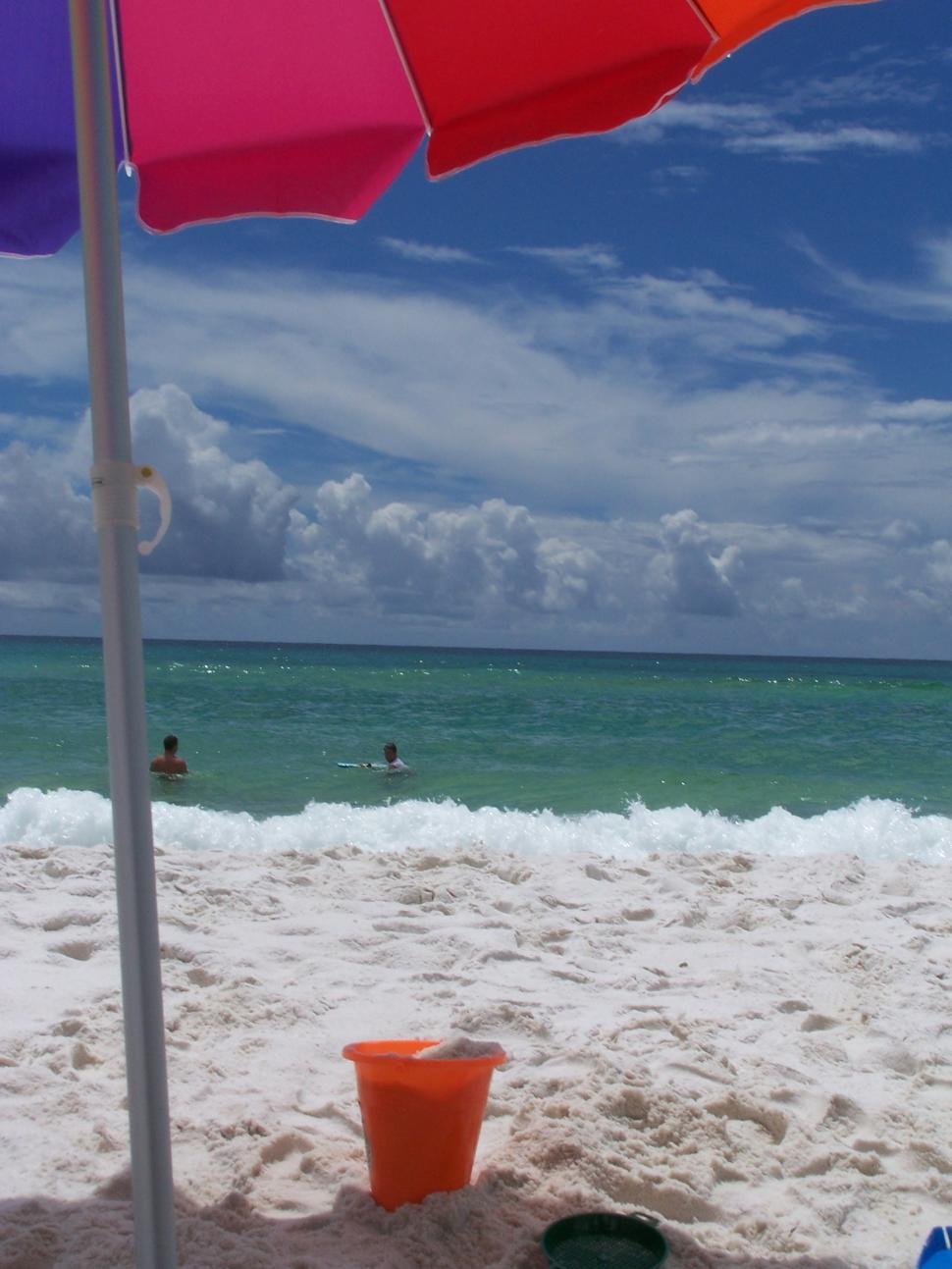 Free Image of Beach Umbrella and Buckets on Beach 