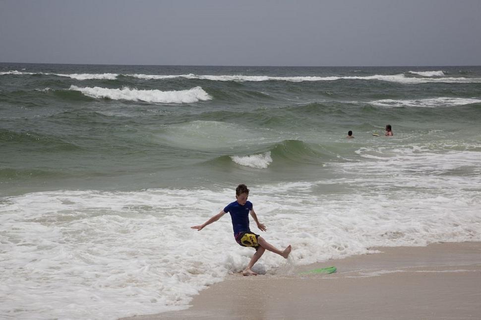 Free Image of Man Running Into Ocean on Beach 