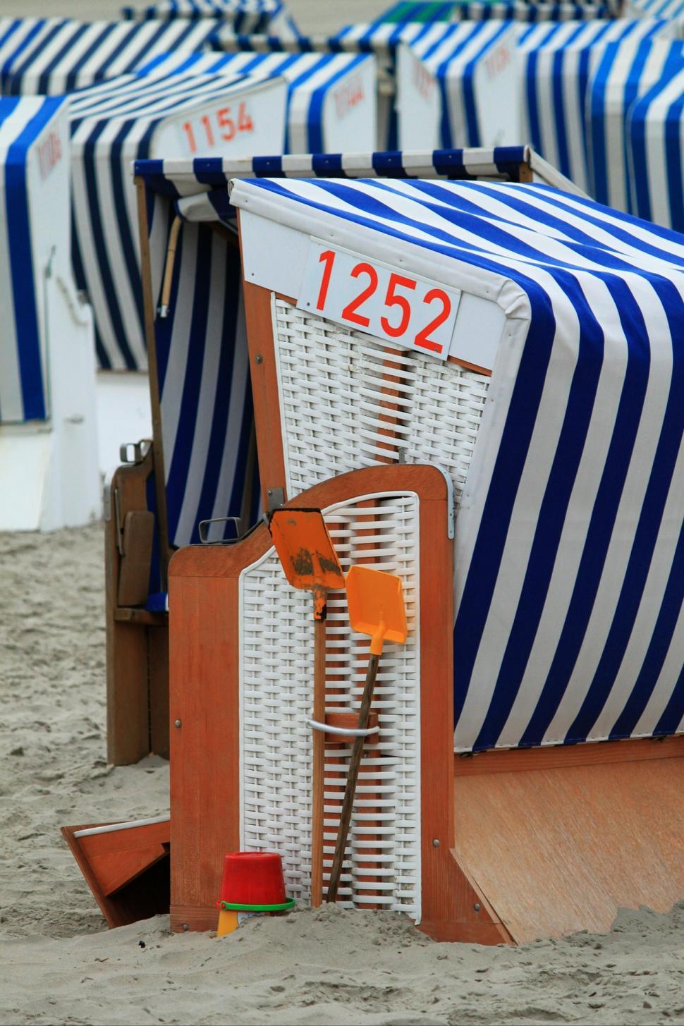 Free Image of Row of Beach Chairs on Sandy Beach 