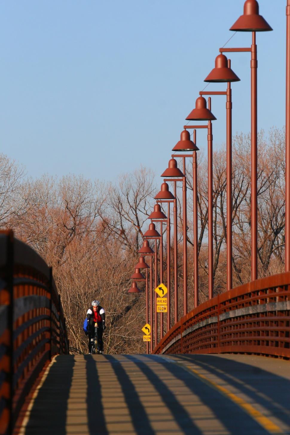 Free Image of Two People Standing on a Bridge 