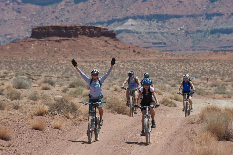Free Image of Group of People Riding Bikes on Dirt Road 