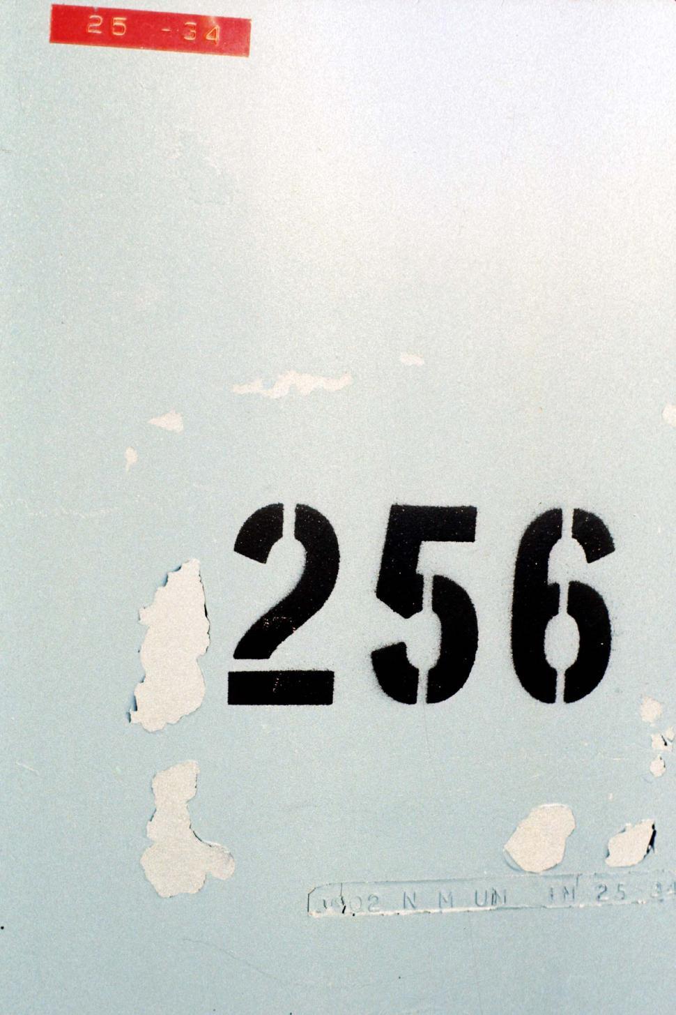 Free Image of numbers apartment address labels 256 peeling stenciled weathered metal painted labelled mailbox 