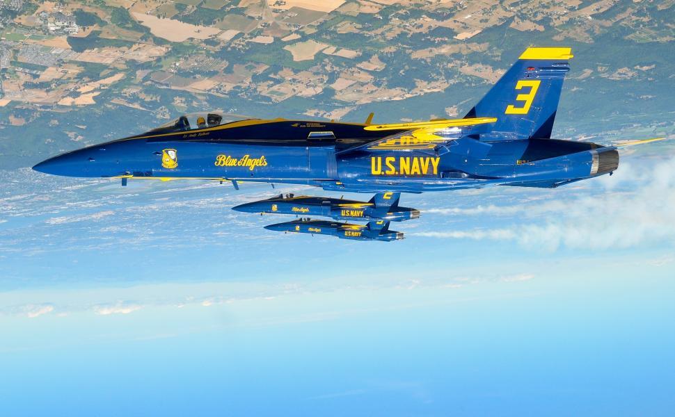 Free Image of Blue and Yellow Fighter Jet Flying Through the Sky 