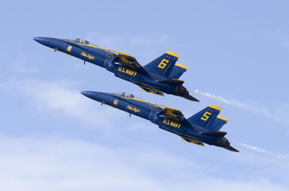 Free Image of Two Blue Fighter Jets Flying Through a Blue Sky 