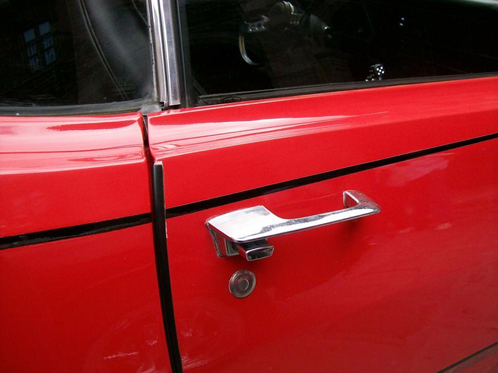 Free Image of Close Up of a Red Car Door Handle 