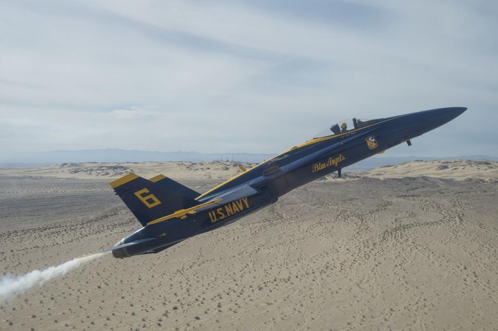 Free Image of Navy Jet Flying Over Sandy Beach 
