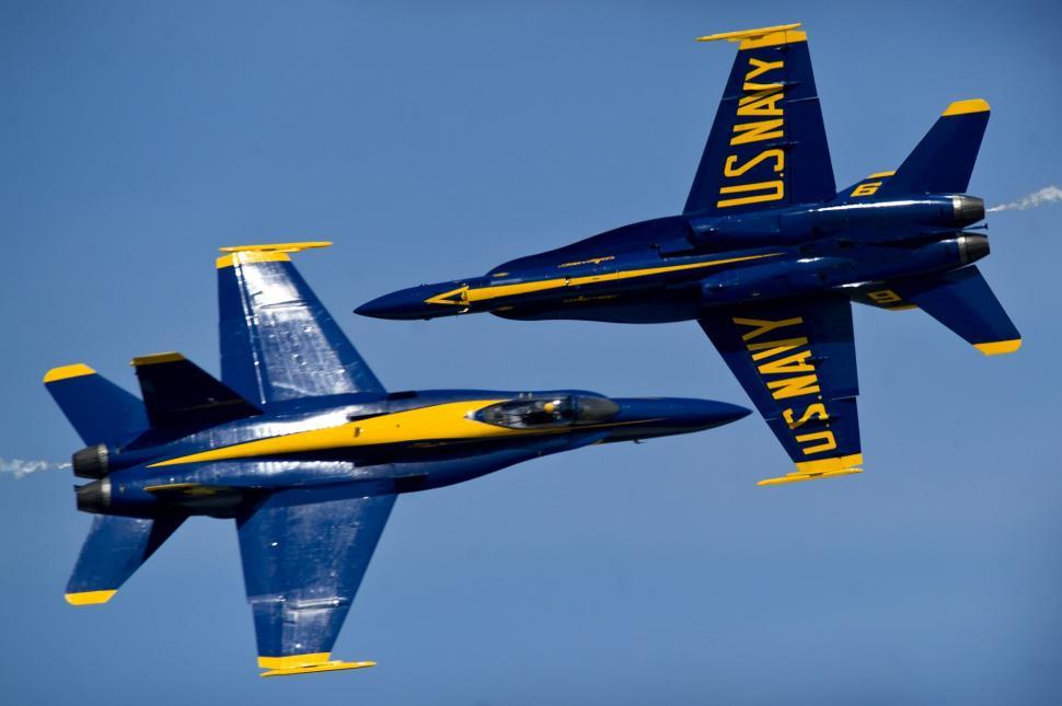 Free Image of Two Blue and Yellow Jets Flying in the Sky 