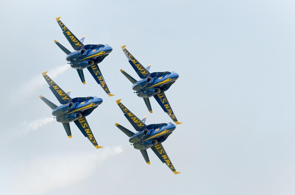 Free Image of Four Blue and Yellow Jets Flying in Formation 