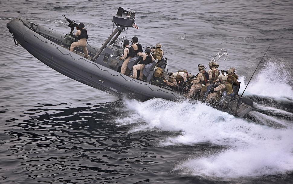 Free Image of Men Riding on the Back of a Boat 