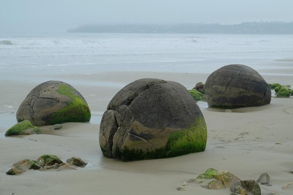 Free Image of Group of Rocks on Sandy Beach 