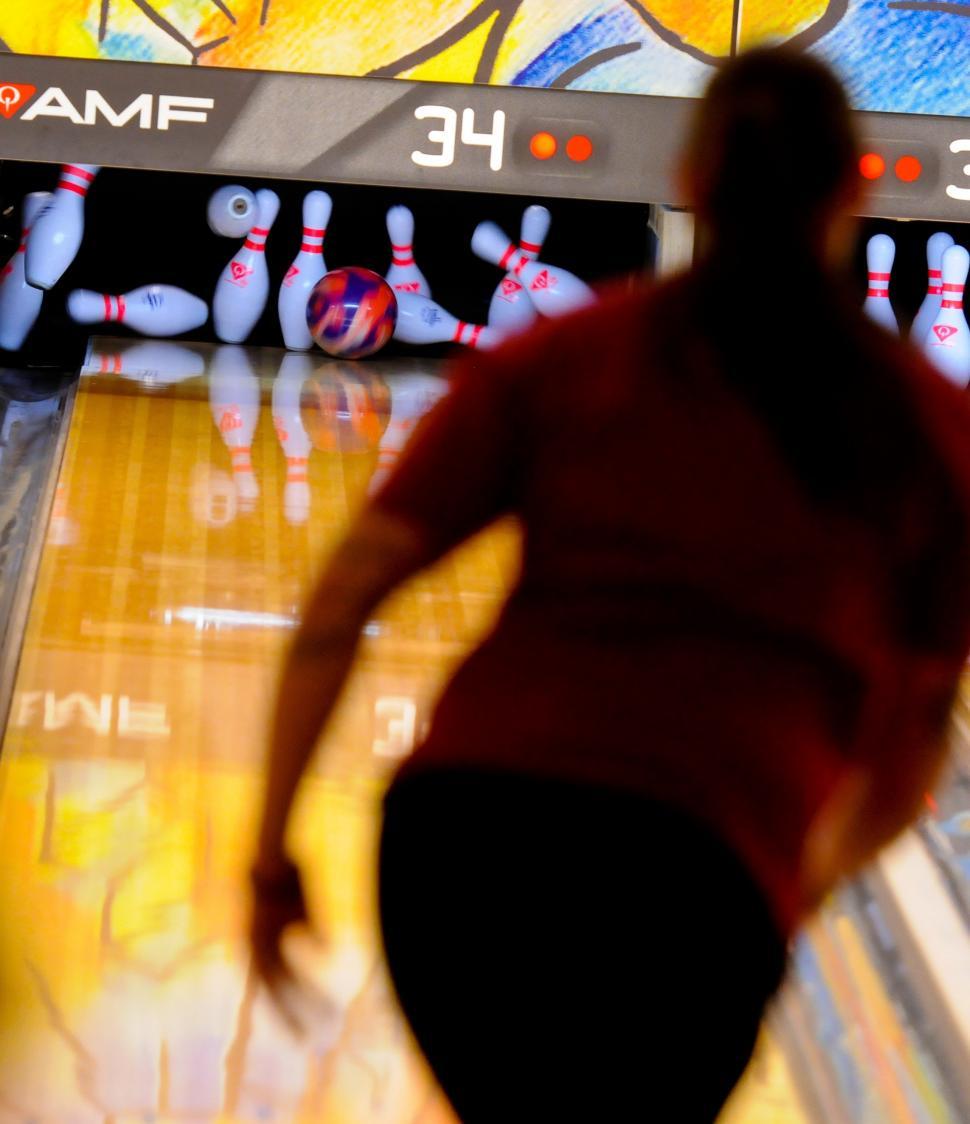 Free Image of Man Bowling Down a Bowling Alley 