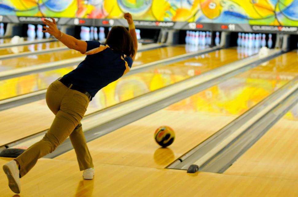 Free Image of Woman Bowling Down a Bowling Alley 