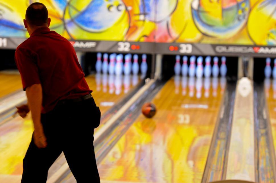 Free Image of Man Standing in Front of Bowling Alley 