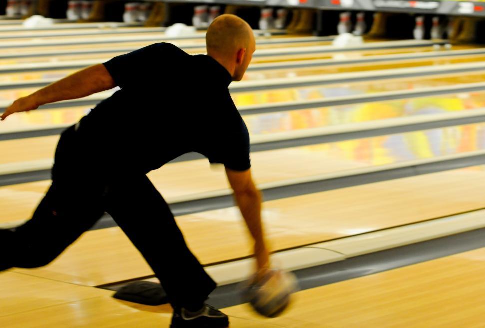 Free Image of Man Bowling Down Bowling Alley 