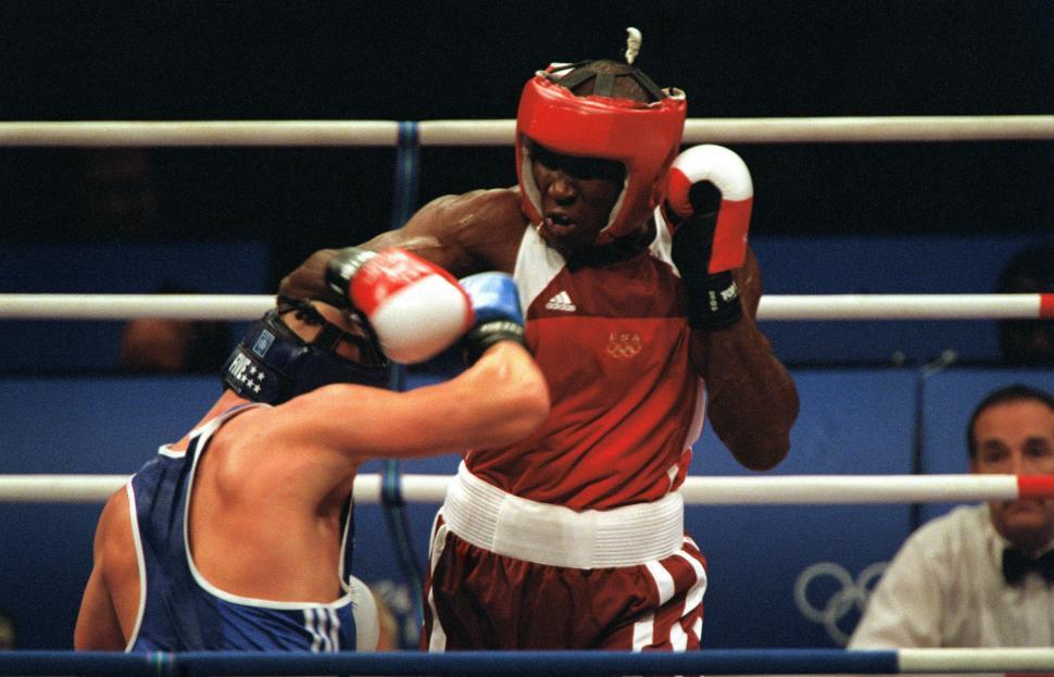 Free Image of Men in Red Shirt and Blue Shorts Boxing 