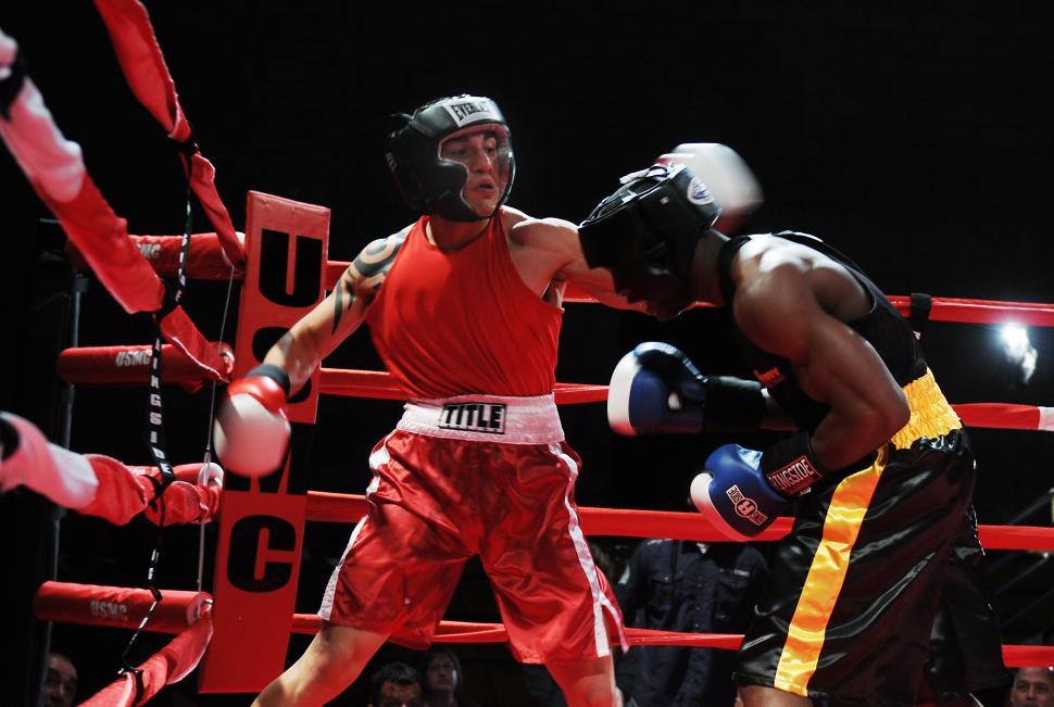 Free Image of Man in Red Shirt and Black Shorts Boxing 