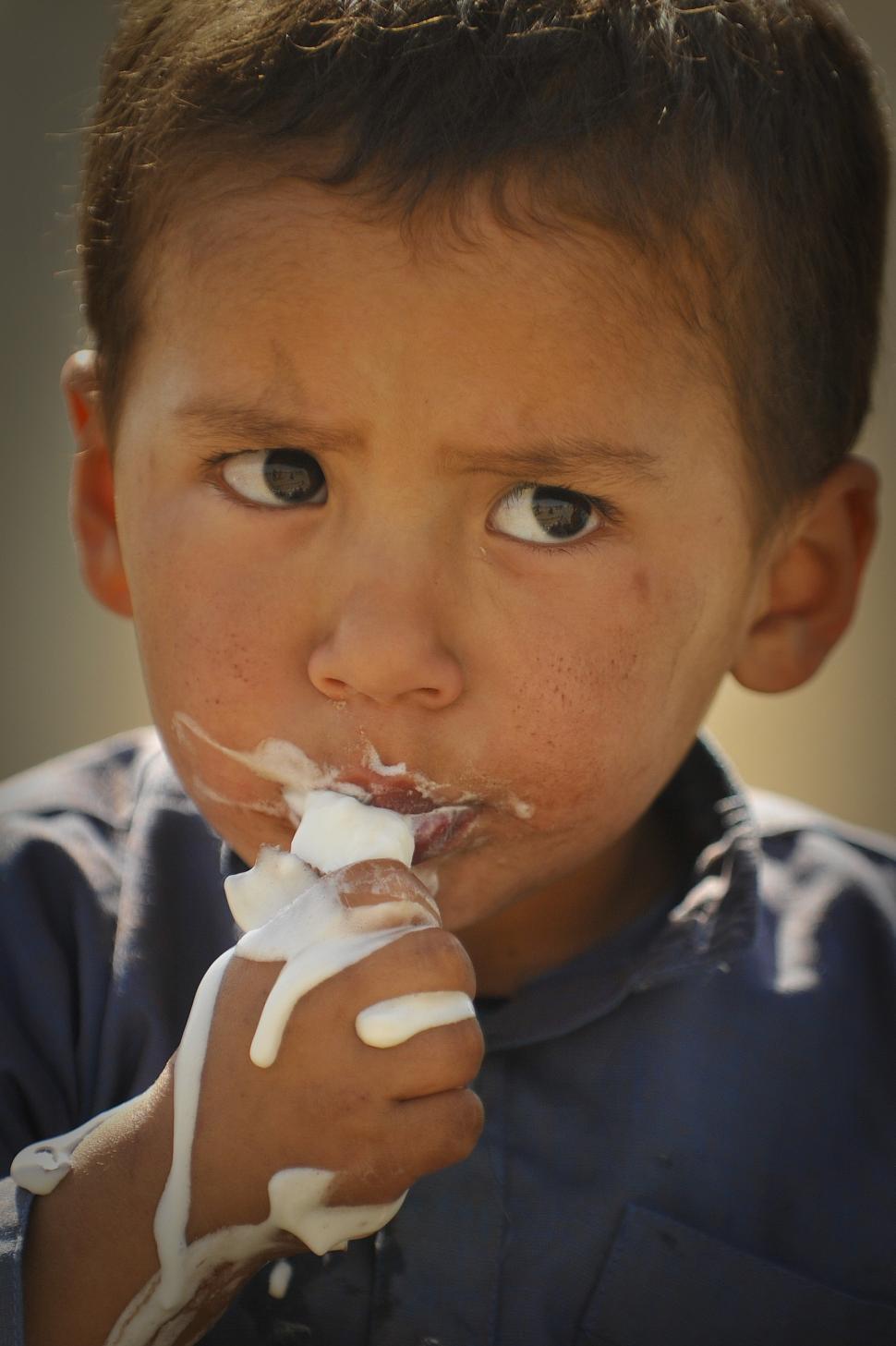 Free Image of Young Boy Eating a Piece of Cake 