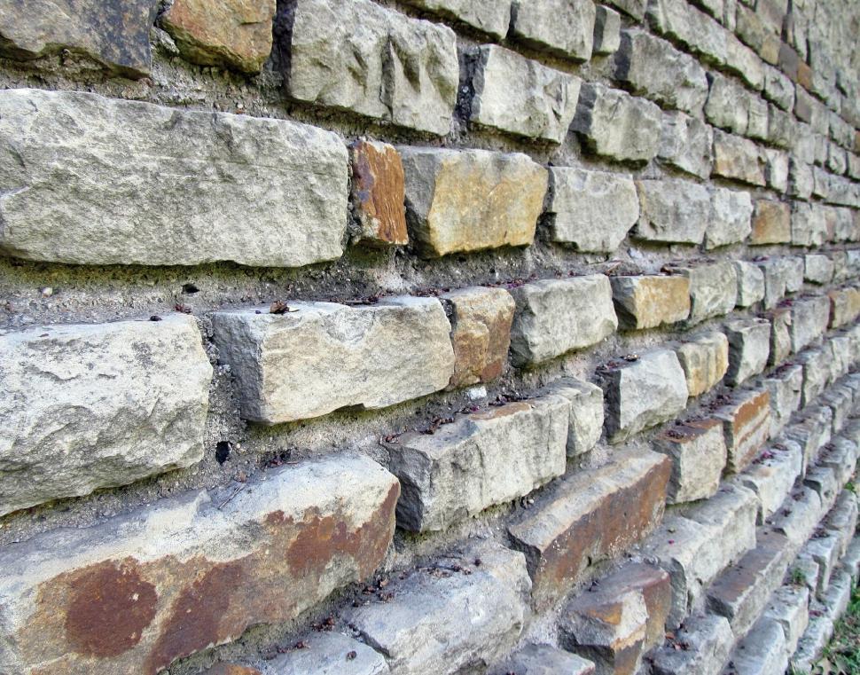 Free Image of brick stone wall wall fence barrier building material stone texture structure pattern old tile obstruction material construction rough surface rock architecture textured concrete cement grunge brown building block 