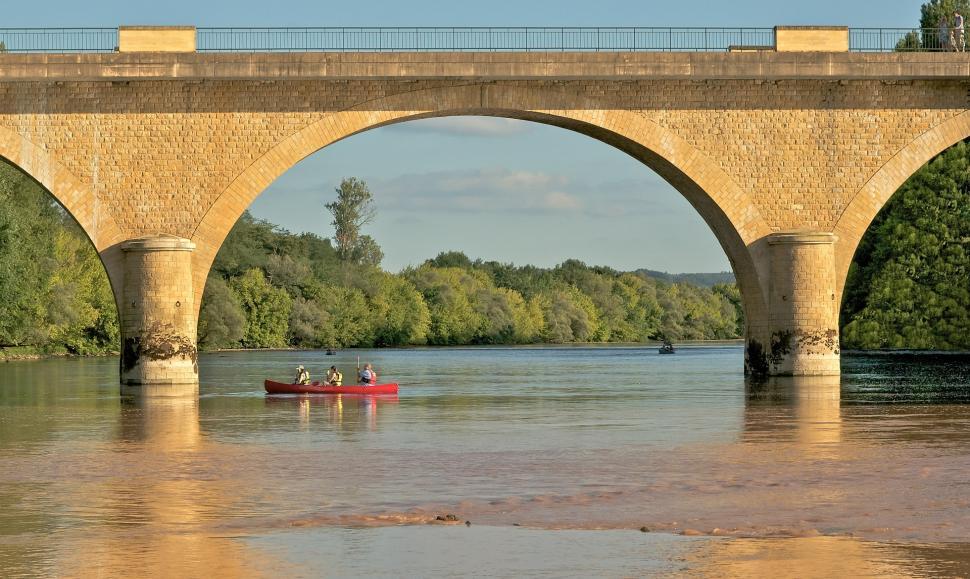 Free Image of People in Red Boat Under Bridge 