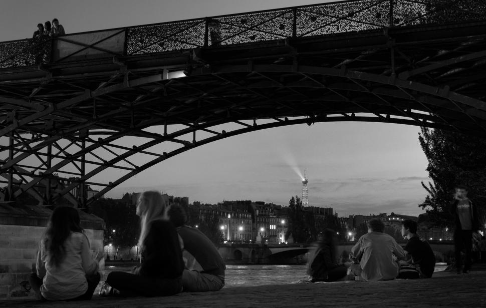 Free Image of Group of People Sitting Under a Bridge 