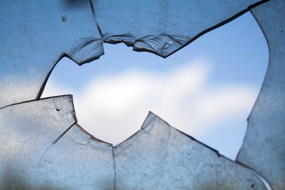 Free Image of Broken Glass Window With Sky in Background 