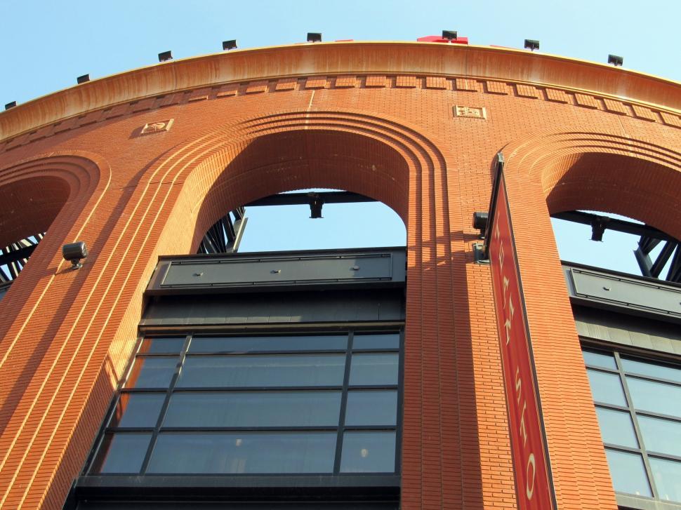 Free Image of Tall Red Brick Building With Arched Windows 