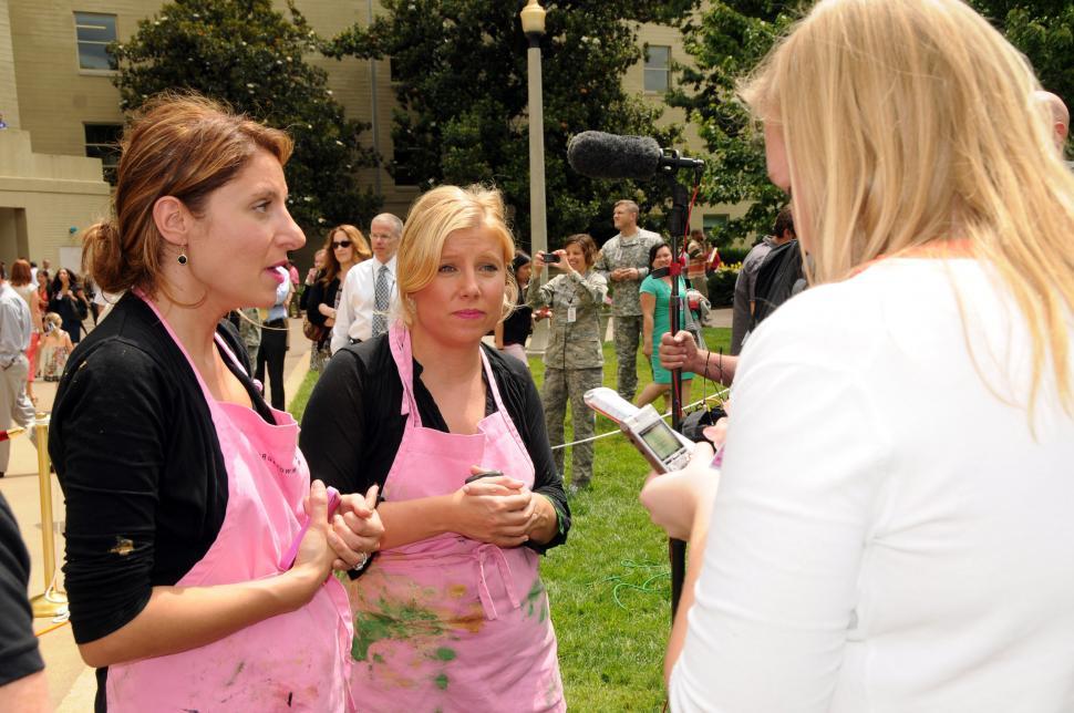 Free Image of Group of Women in Aprons Talking 