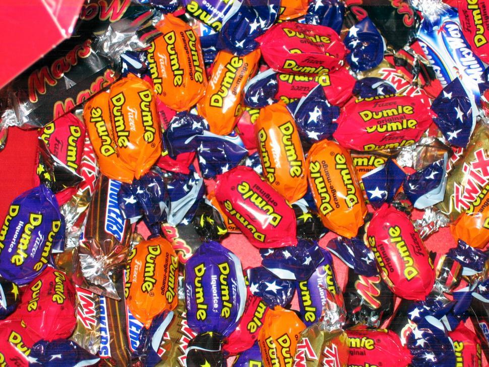 Free Image of Pile of Candy With Red Box in Background 