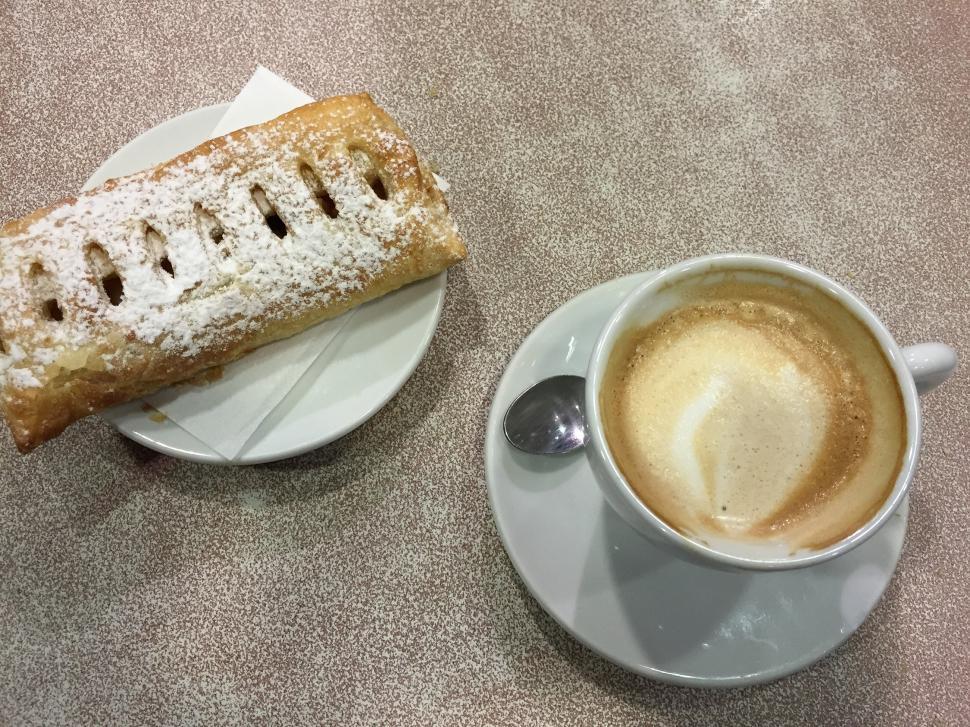 Free Image of A Cup of Coffee and a Pastry on a Saucer 