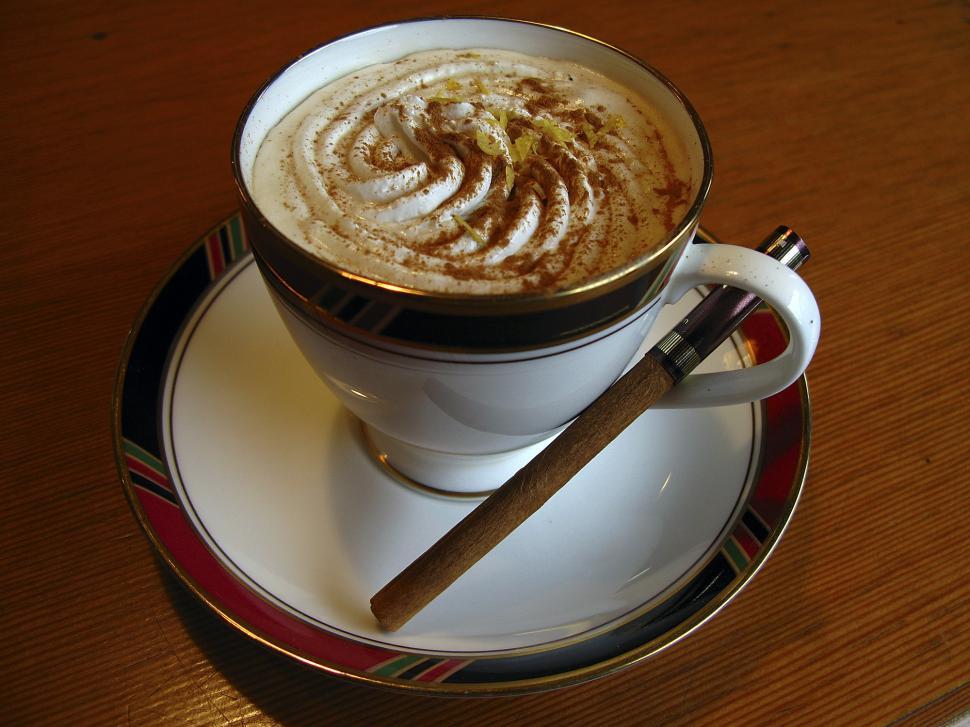 Free Image of A Cappuccino With Cinnamon Stick on a Saucer 