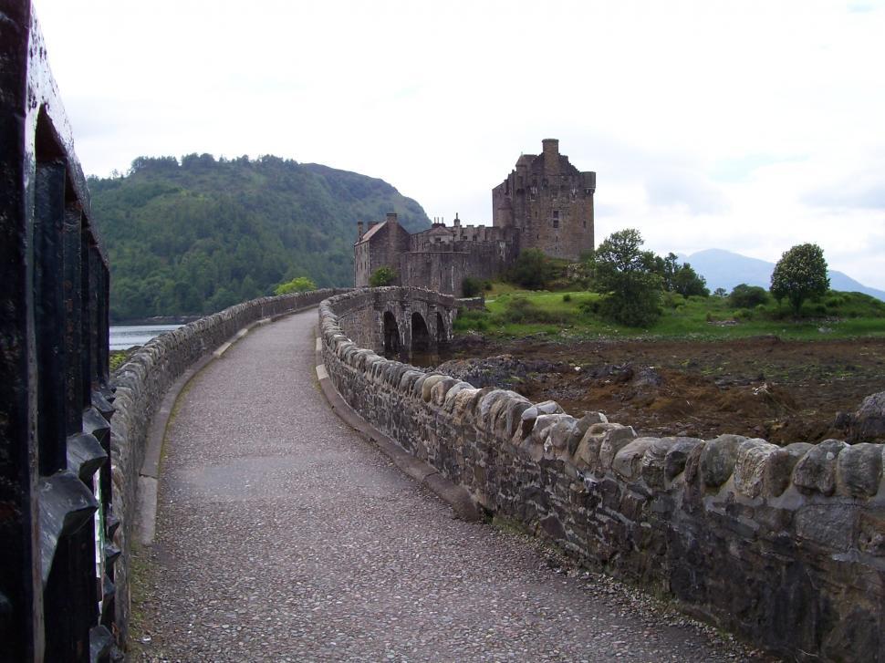 Free Image of Stone Bridge With Castle in Background 