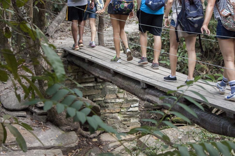 Free Image of Group crossing a wooden bridge 