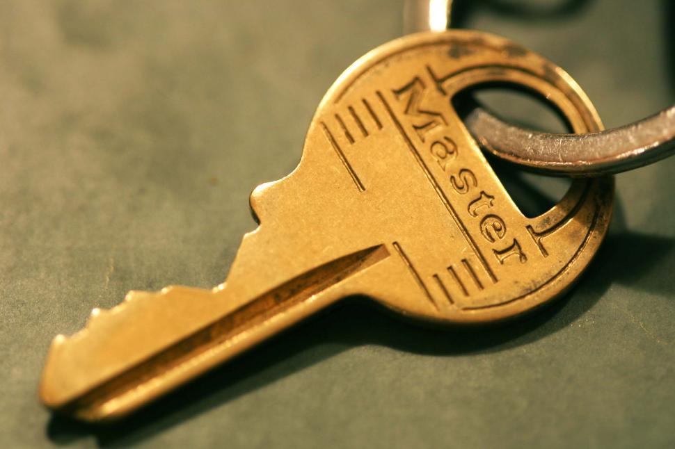 Free Image of Shiny Golden Key With Key Chain Attached 