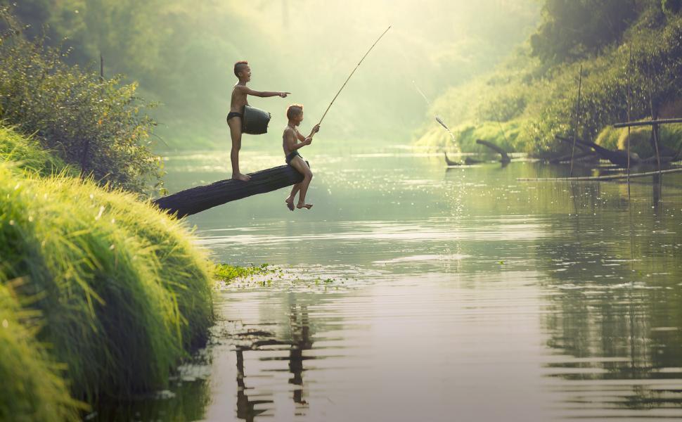 Free Image of Two Boys Fishing on a Log in a River 
