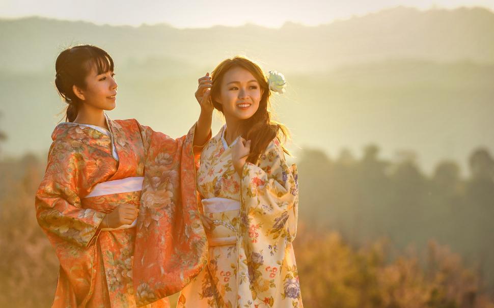 Free Image of Two Women in Kimonos Standing in a Field 