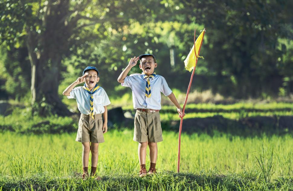 Free Image of Two Young Boys Standing in a Field 