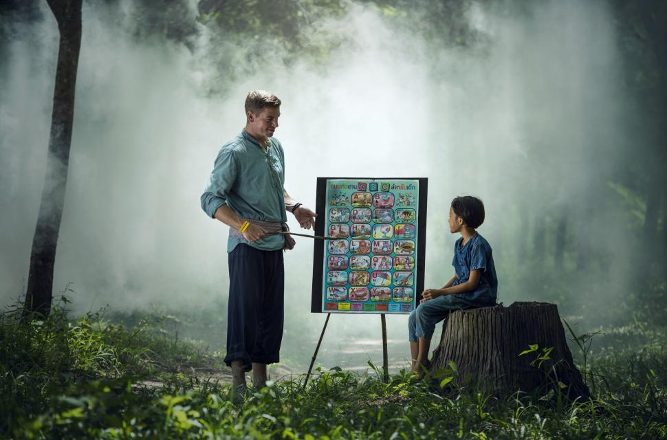 Free Image of Man and Boy Standing in Forest 