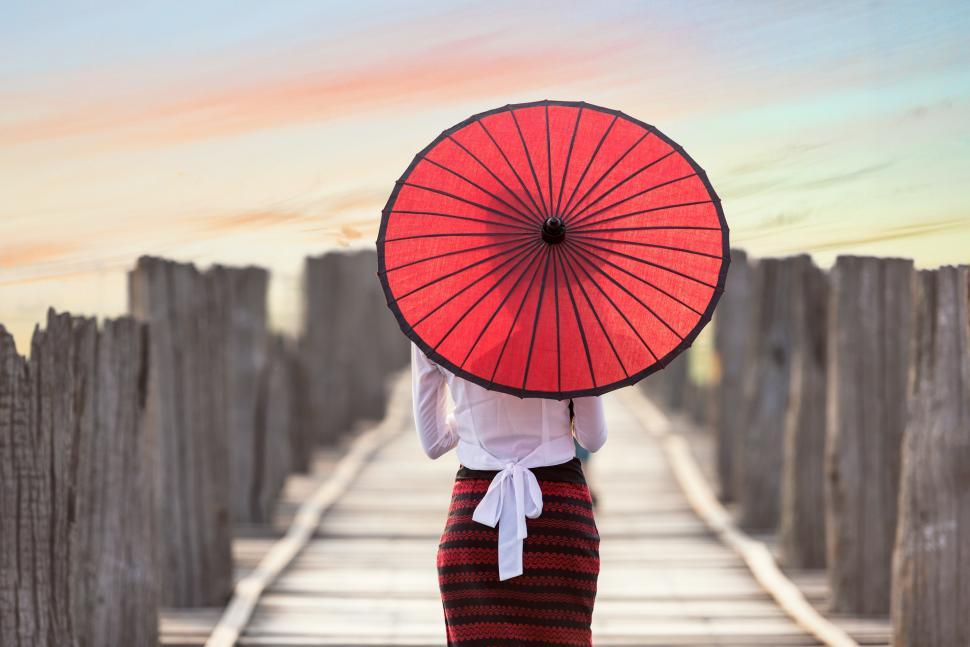 Free Image of Woman With Red Umbrella Walking on Bridge 