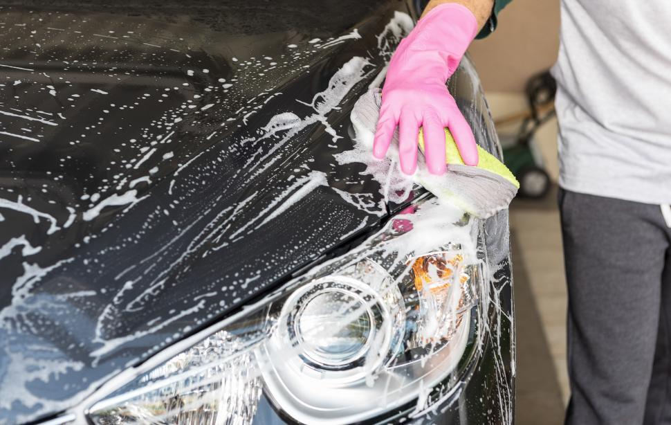 Free Image of Person Washing Car With Sponge 