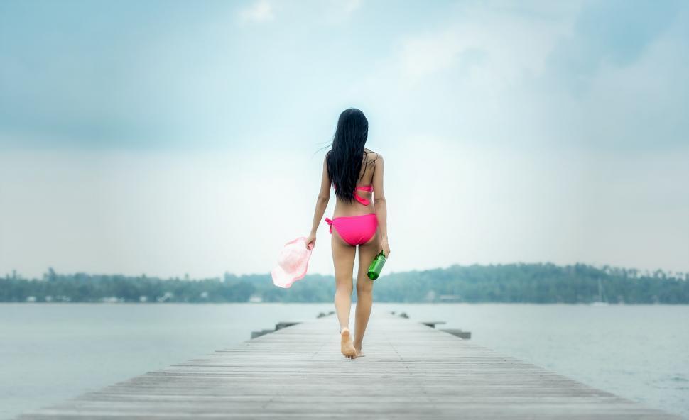 Free Image of Woman in Pink Bikini Walking on Pier 