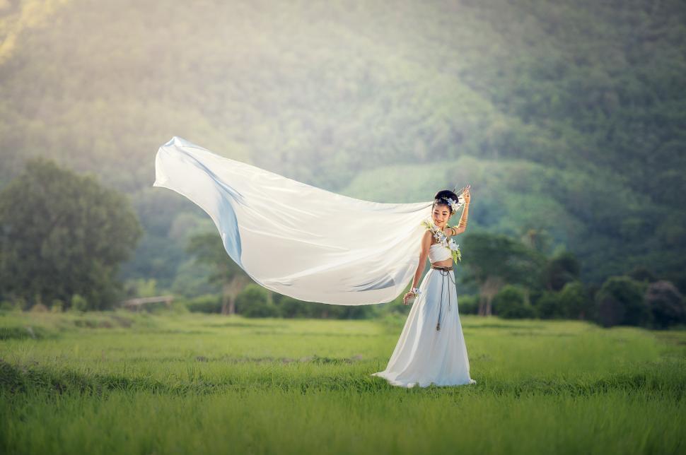 Free Image of Woman in White Dress Holding White Shawl 