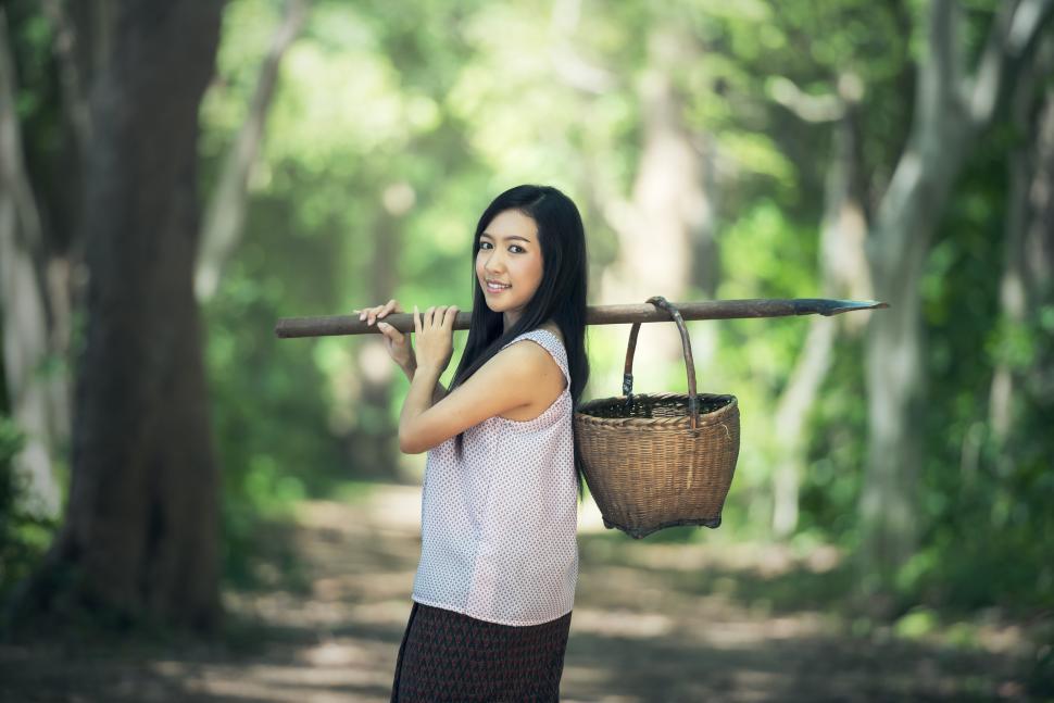 Free Image of Woman Carrying Basket on Shoulder 