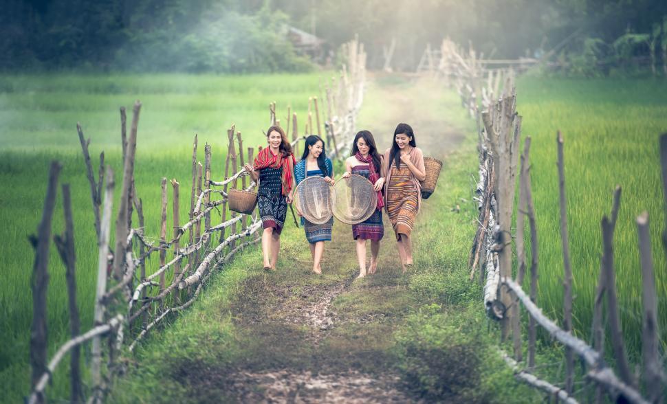 Free Image of Group of Women Walking Down a Dirt Road 