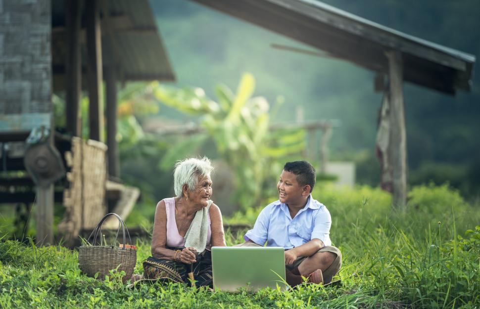 Free Image of Man and Woman Working on Laptop in Grass 