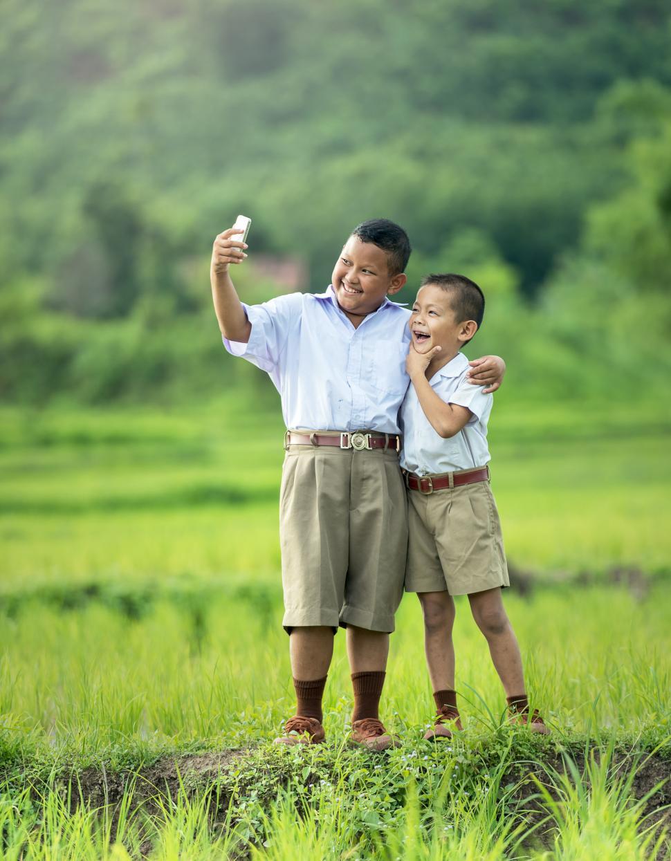 Free Image of Man and Boy Standing in Field 