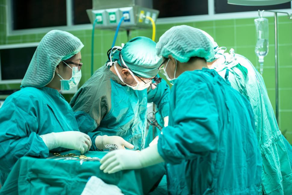 Free Image of Group of Doctors Performing Surgery in Operating Room 