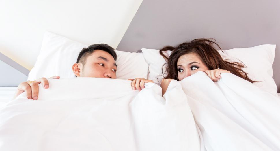 Free Image of Man and Woman Hiding Under a Blanket 